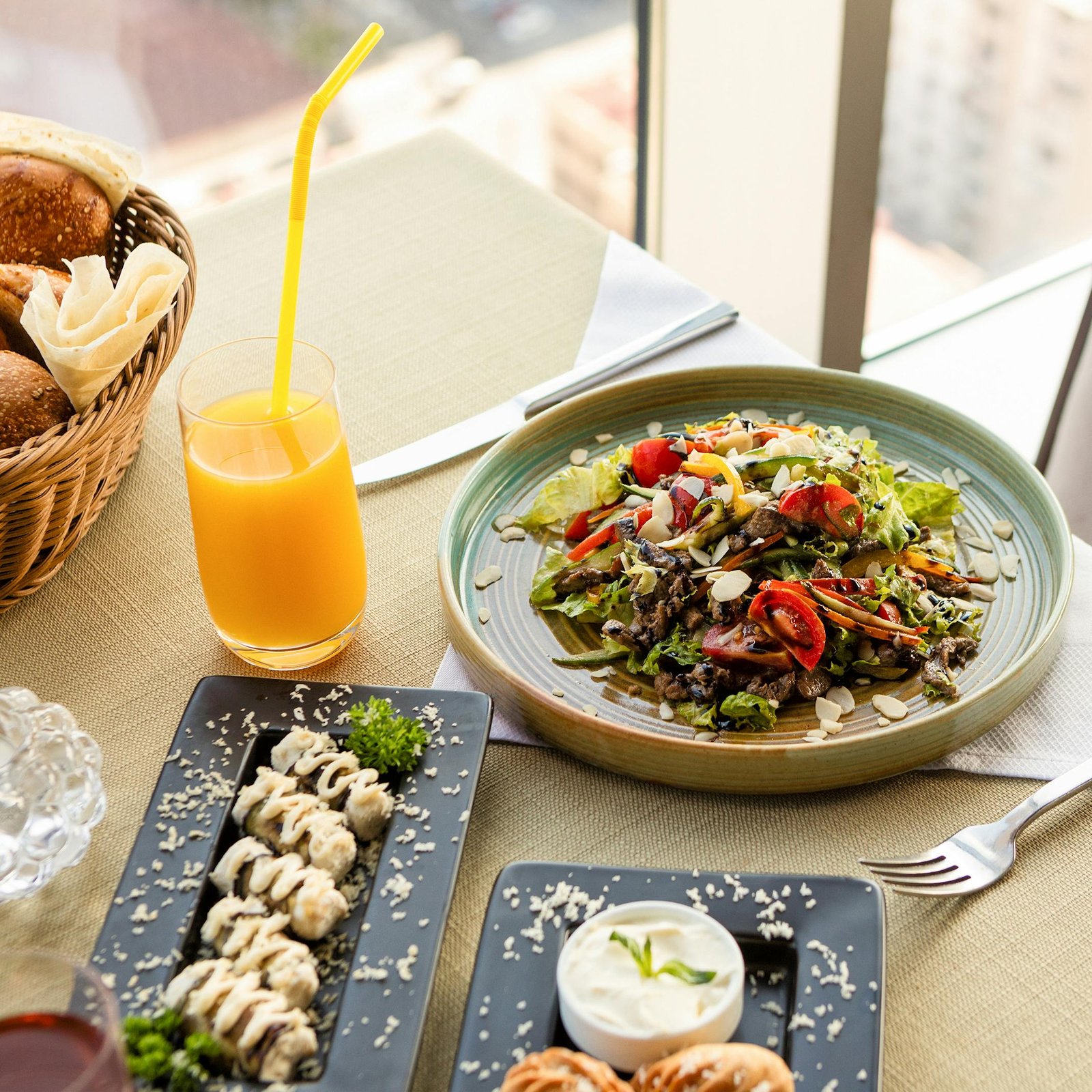 Enjoy a vibrant salad and refreshing juice in an elegant setting with city views, perfect for brunch.
